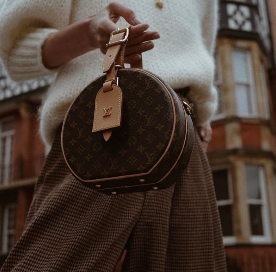 Woman holding a stylish preowned designer bag Woman holding a stylish preowned designer bag