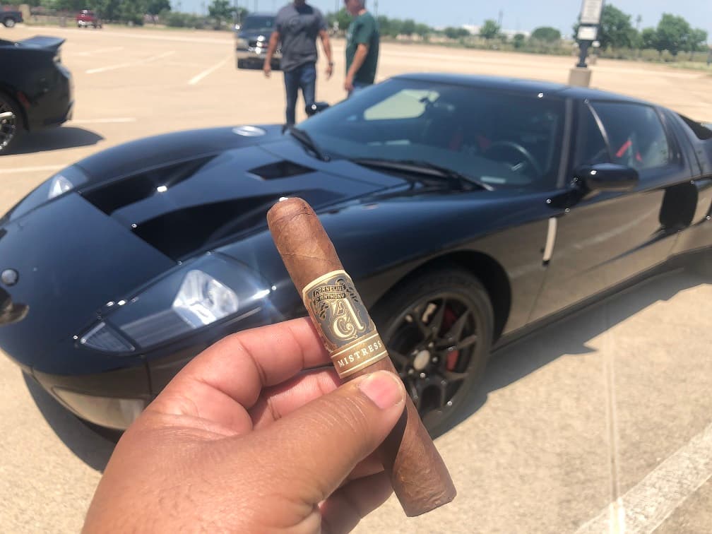 Luxury cars and premium cigars on display Luxury cars and premium cigars on display