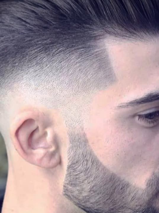 Skilled barber at work with client Skilled barber at work with client