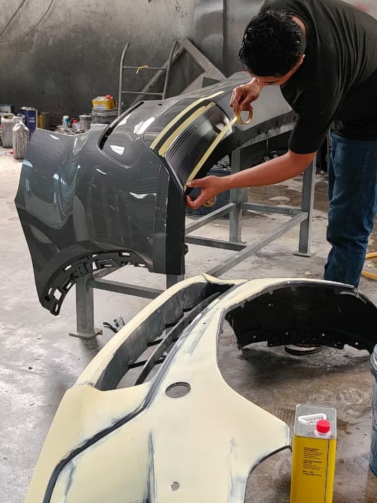 spray painter working on car spray painter working on car